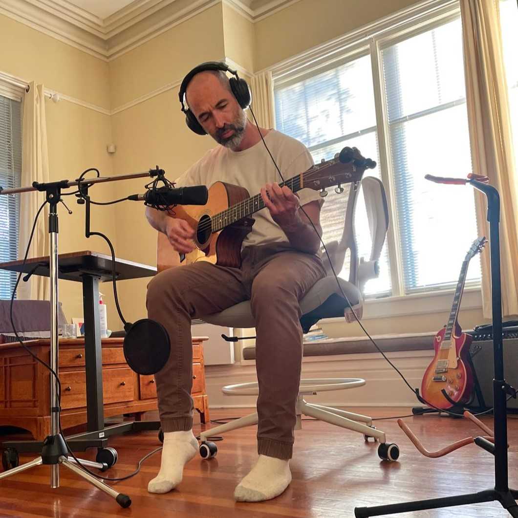 David Gaskin playing guitar in his Victoria studio